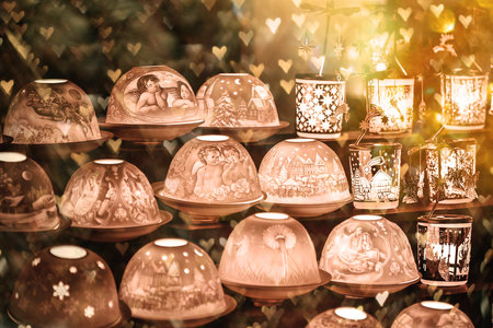 Many decorated Christmas lamps stand as decoration on a table against a blurred background. Christmas background.の写真素材