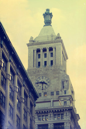 Clock tower with a clock. The tower is tall and has a dome on top. East Village, New York.の写真素材