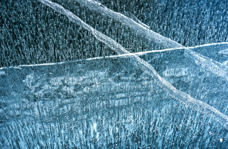 Ice blue texture. The image is of ice with a lot of small spikes. The ice is blue and white, and the spikes are white. The image has a cold and icy feel to itの写真素材