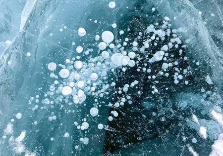 Ice blue texture. Ice blue colored natural marble panel, texture background. The bubbles are scattered throughout the water, creating a sense of movement and energy.の写真素材