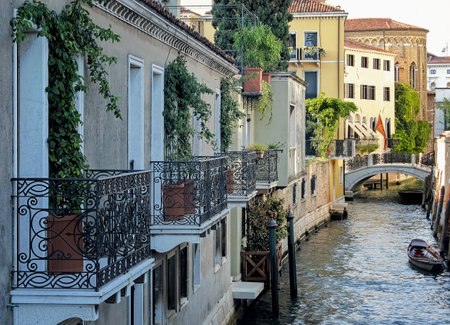 Channel in Venice. Romantic view of a Venetian channel. Row of buildings with balconies overlooking a canal. View of the canal in the morning at dawn. Venice, Italy.の写真素材