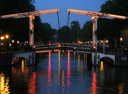 Amsterdam at night. Canal and bridge in Amsterdam in the evening. Illuminated bridge in Amsterdamの写真素材