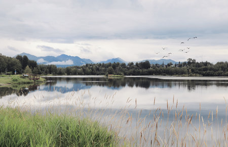 Spectacular view of Westchester Lagoon near Anchorage, Alaska, United States. The Chugach Mountains are visible on the horizon. Alaskan Landscape.の写真素材