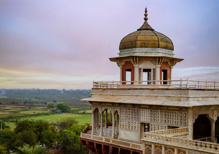Musamman Burj (Jasmine Tower) - a two-story tower pavilion with a beautiful marble balcony proudly rises above the surroundings. Large building with a dome on top and a balcony.の写真素材