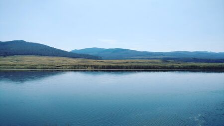 A small river with a beautiful view of the mountains and the elevationの写真素材