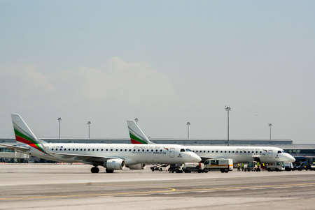 Embraer erj-190 of Bulgaria Air airplanes are seen parked in front of the Terminal 2 of Sofia airport, Sofia, Bulgaria, April 22, 2014.のeditorial素材
