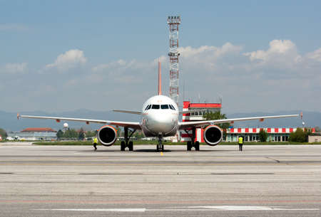 easyJet Airbus A320 has just landed at the runway of Sofia airport, Sofia, Bulgaria, April 22, 2014. Service airport workers are prepairing to unload the jet.のeditorial素材