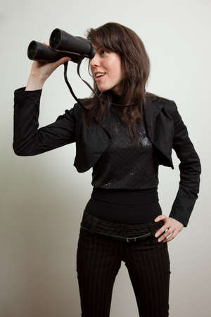 Young woman holding binocularsの写真素材