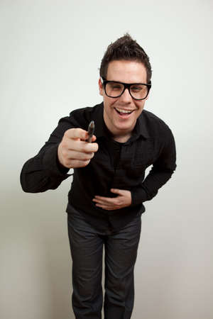 Young man standing and laughing