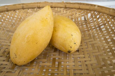 fresh mango on the bamboo trayの写真素材