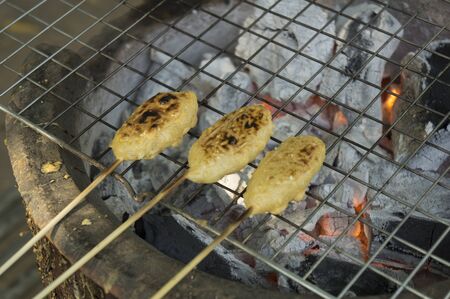 charcoal grill with rice on stickの写真素材
