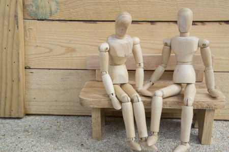 Wooden couple people sit on benchの写真素材