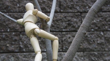 wooden human figure climb treeの写真素材