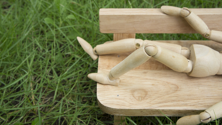 wooden human figure sleep bench gardenの写真素材