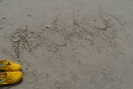 sand writing word vacation beach relaxの写真素材