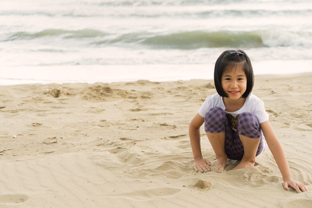 Little girl have fun on the beach.の写真素材
