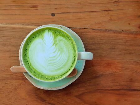 hot matcha green tea latte with Flower Latte art on topの写真素材