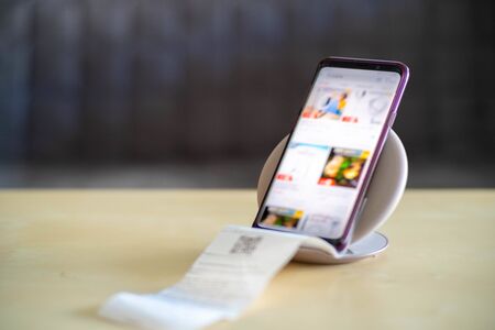 Selected Focus on Mobile Phone with blur display of Shopping Online and have a bill come from the Mobile Phoneの写真素材