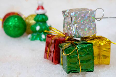 The Group of Christmas Presents and Christmas Tree on White Snow for Background Wallpaperの写真素材