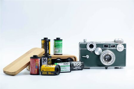 A Group of 35mm Negative films : Fujifilm ,Kodak , Agfa ,Lomography and Argus C3 American Camera and The Wooden Film Case isolate on white backgroundのeditorial素材