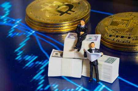 Miniature people businessman sitting on Dollar Banknote with market trading candlestick chart and Golden Coin in Background. Investing in Stock Market Trading conceptの写真素材