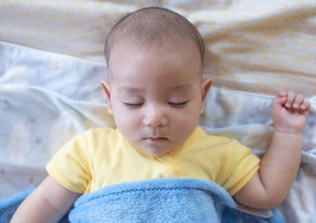 The Sleeping cute New Born Baby infant on the bed