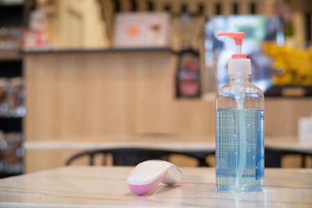 Hand Sanitizer or Hand Gel or Hand Cleanser with Alcohol 70% and Digital Thermometer on the table in the Restaurant and Cafe for Checking Customerの写真素材