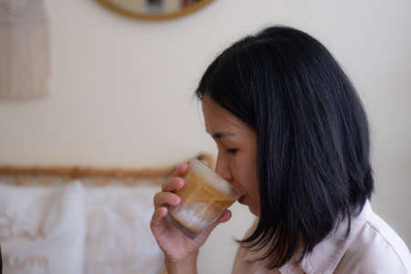 Woman is Drinking a glass of Coffee menu called Dirty Coffeeの写真素材