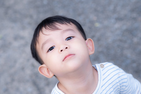 A face of baby boy todler looking upの写真素材