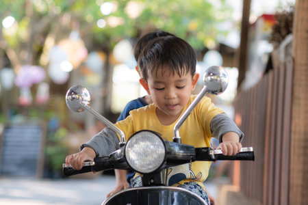 Baby Boy toddler riding driving Motorcycle or motorbikeの写真素材