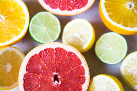 citrus fruits (grapefruit, orange, lemon, lime), top view on the wooden background.の写真素材