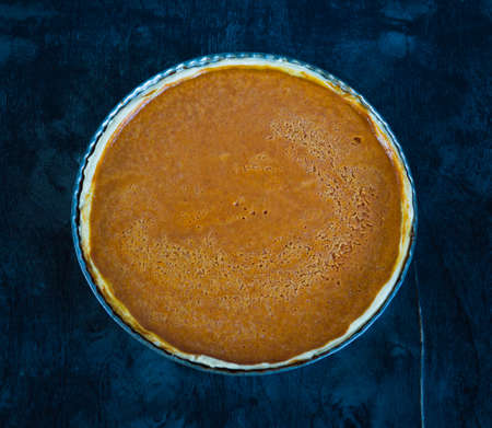 Pumpking pie on black wooden desk. Thanksgiving dinner. Autumn