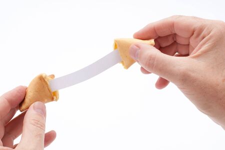 Fortune cookie held open to reveal extra long blank fortuneの写真素材