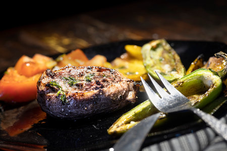 Filet Mignon Dinner with a stuffed potato and roasted peppers.の写真素材