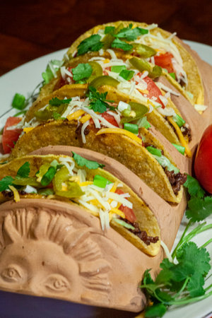 Bright and colorful taco dinner with salsa, crispy taco shells and jalapenos.