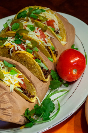 Bright and colorful taco dinner with salsa, crispy taco shells and jalapenos.の写真素材