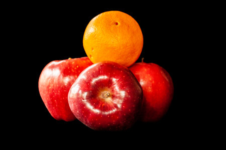 Collection of an orange and apple isolated on black.の写真素材