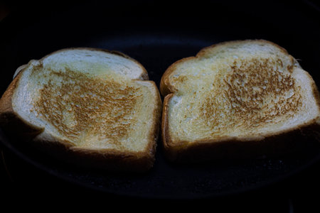 Toasting bread in a pan with butter.