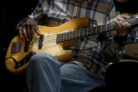 Close up of a musician playing a guitar.