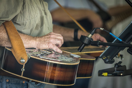 Close up of a musician playing a guitar.