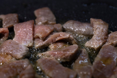 Beef strips cooking in a pan.の写真素材
