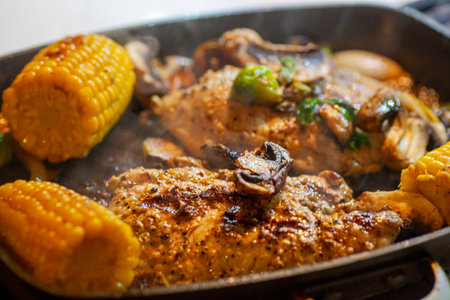 Pan grilled porkchops with corn and sides.の写真素材