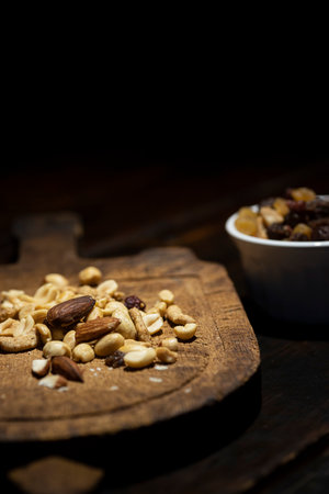 Mixed nuts trail mix on antique cutting board.
