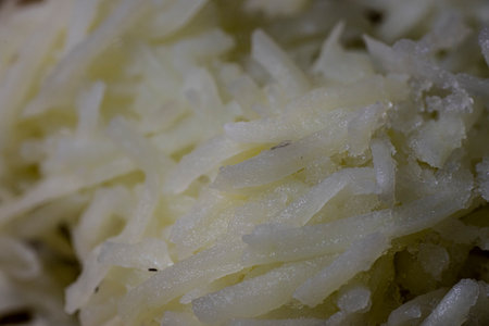 Shredded hash browns plated on blue plate.
