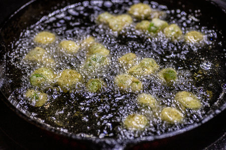 Fried okra cooked and on a antique cutting board.の写真素材