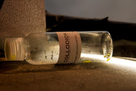 Collodion in labeled glass jar.