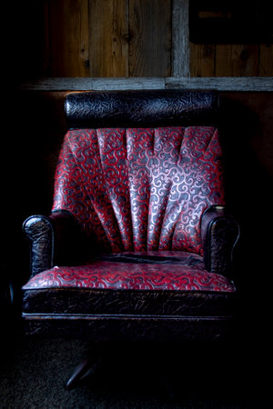 Antique red leather chair with trim.の写真素材