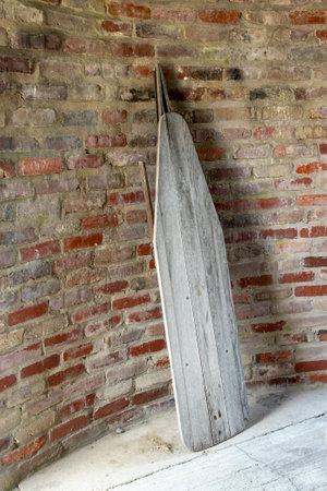 Antique wooden ironing board against bricks.の写真素材