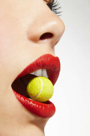 lips bitting sugar tennis ballの写真素材