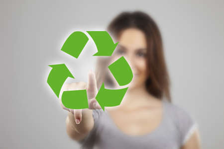 Young woman pointing at recicle iconsの写真素材